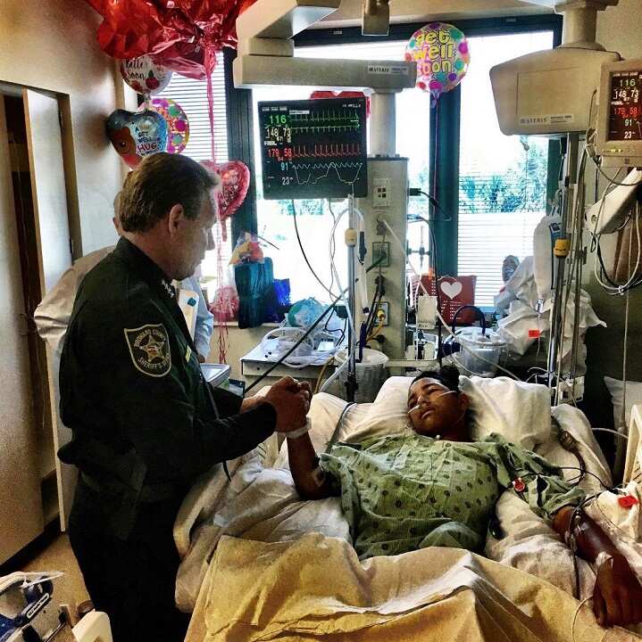Sheriff Scott Israel holds the hand of Anthony Borges, 15, a student at Marjory Stoneman Douglas High School. 