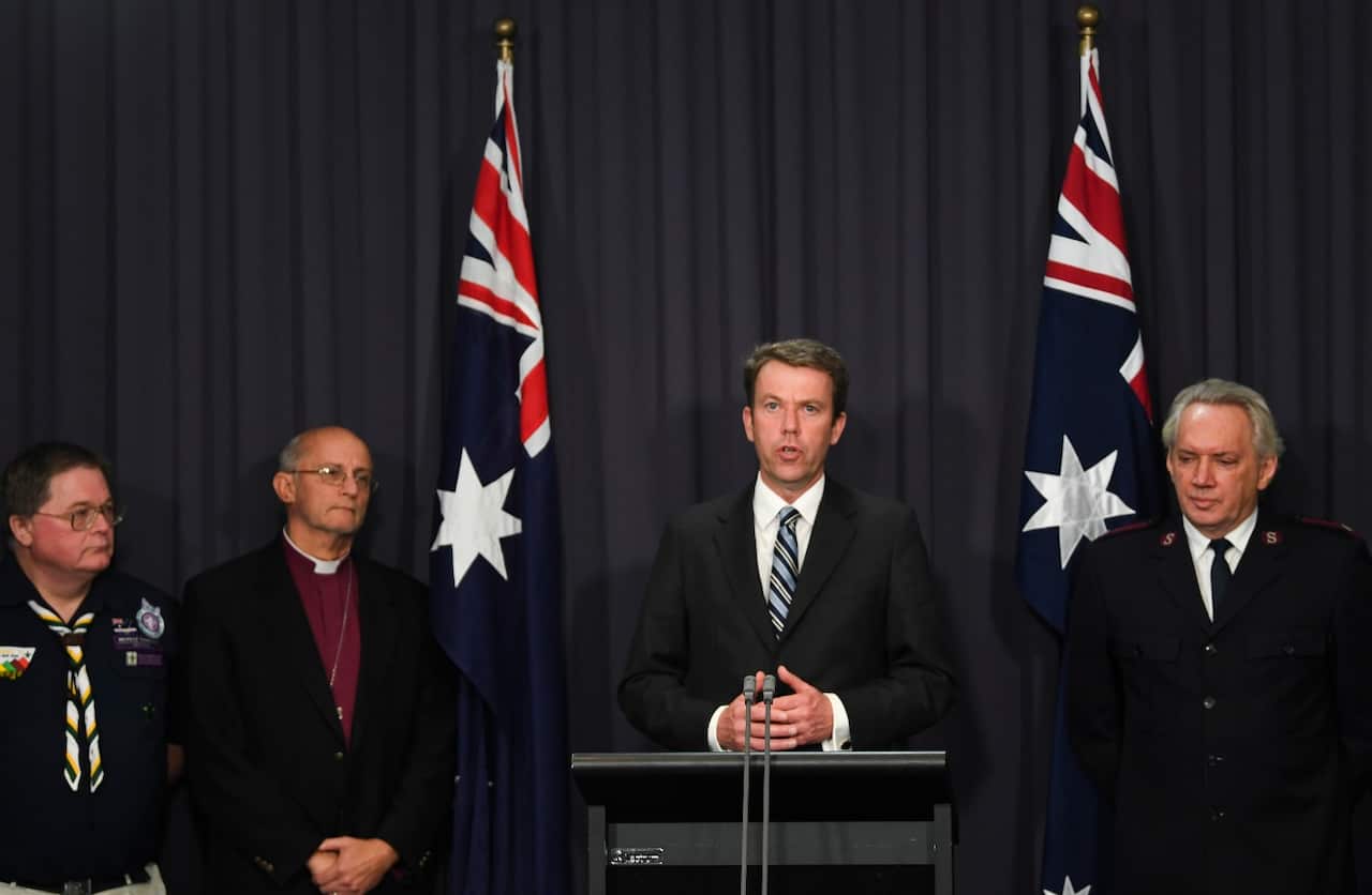 Australian Social Services Minister Dan Tehan and representatives of four non-government institutions speak during a press conference at Parliament House in Canberra