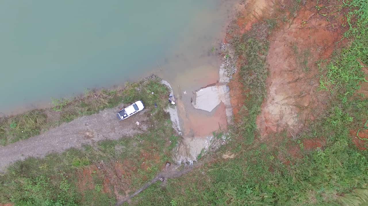 Water spills over the Gold Ridge tailings dam wall