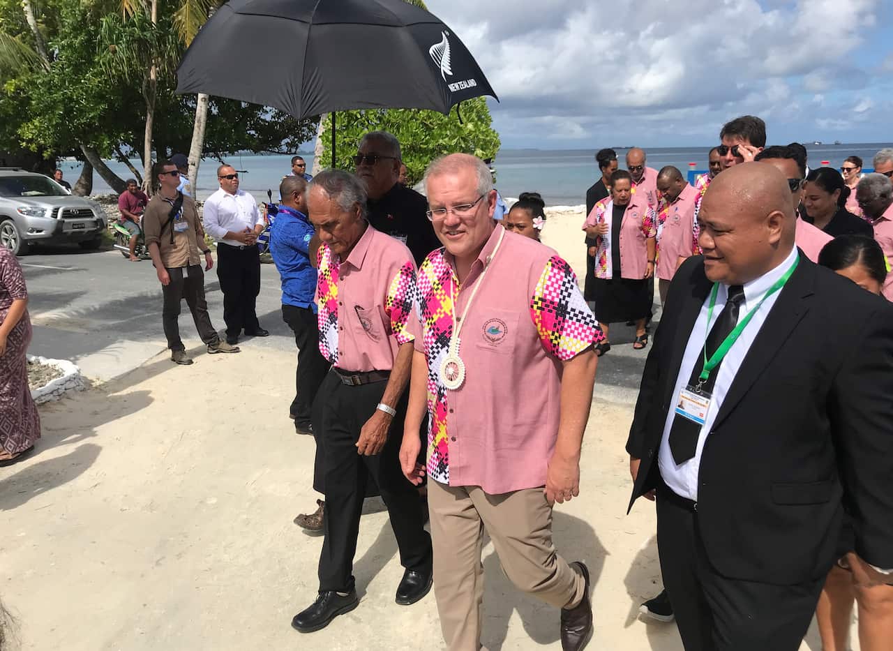 The late Tongan PM walks alongside Australian PM Scott Morrison at Pacific Island Forum leaders' meeting last month in Tuvalu.
