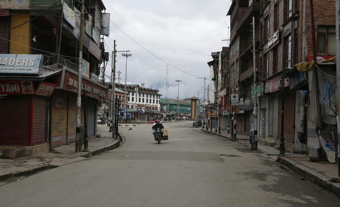 A man rides on a deserted street during lockdown in Srinagar.