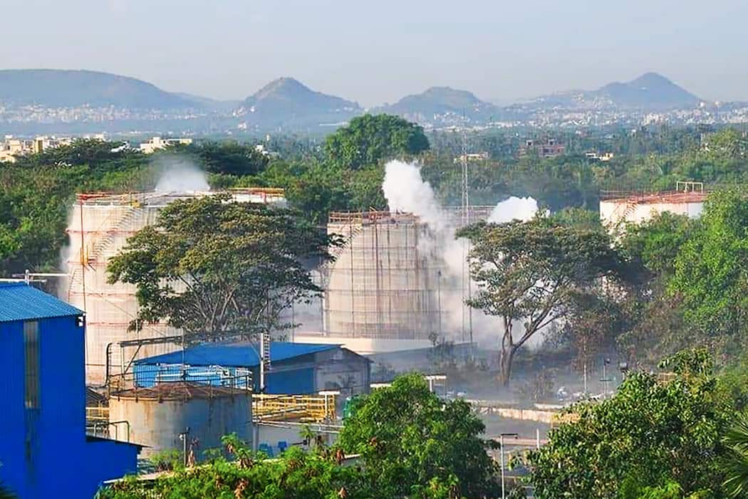 Smokes rise from the LG Polymers plant.