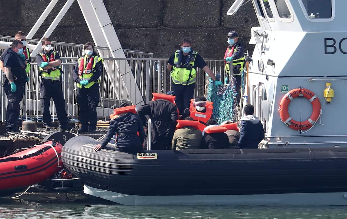 Border Force officers prepare to bring to shore men thought to be migrants in Dover.