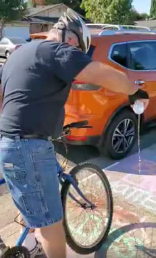 A man filmed pouring water over a 'Black Lives Matter' chalk drawing. 