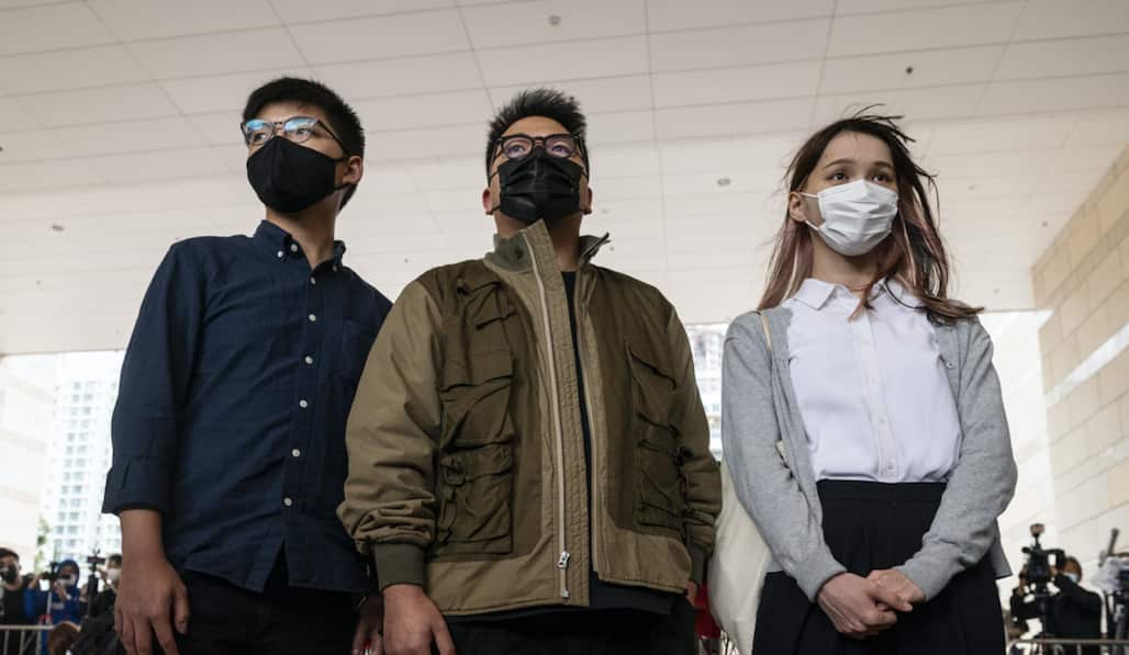 Joshua Wong (L), Ivan Lam (C), and Agnes Chow (R) arrive at the West Kowloon Law Courts building last month