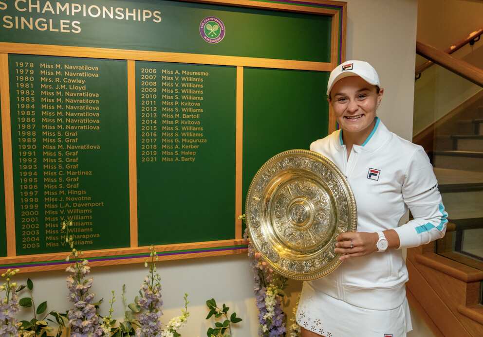 Ash Barty poses with the Venus Rosewater Dish and the Ladies’ Singles Board 