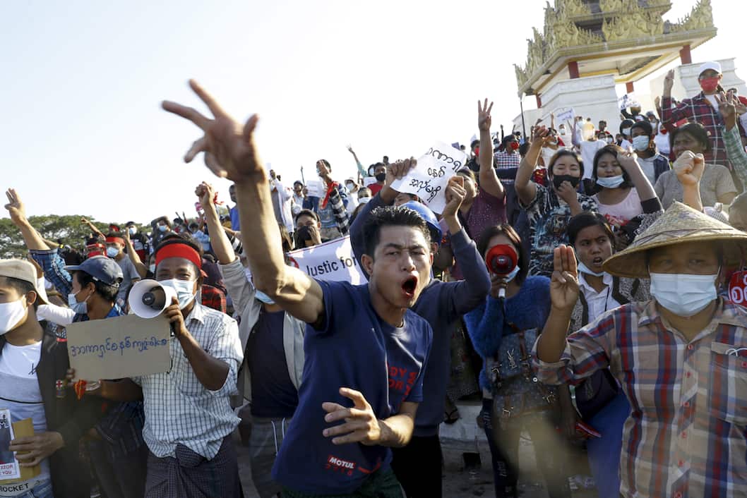 Demonstrators flash a three-fingered symbol of resistance against the military coup and shout slogans calling for the release of detained Myanmar State Counselor Aung San Suu Kyi during a protest in Mandalay, Myanmar on 10 February 2021.