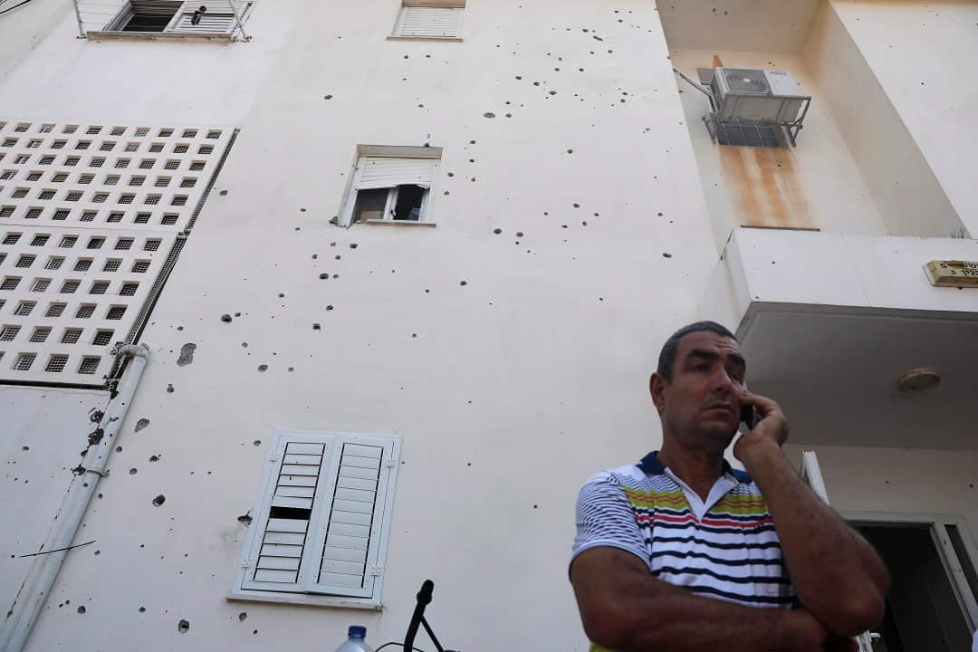 An Israeli man outside a house in Sderot damaged by shrapnel from a rocket fired from Gaza.