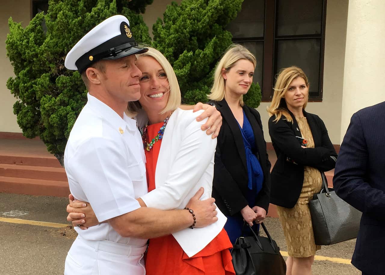 Gallagher, left, hugs his wife, Andrea Gallagher, after  being cleared. 