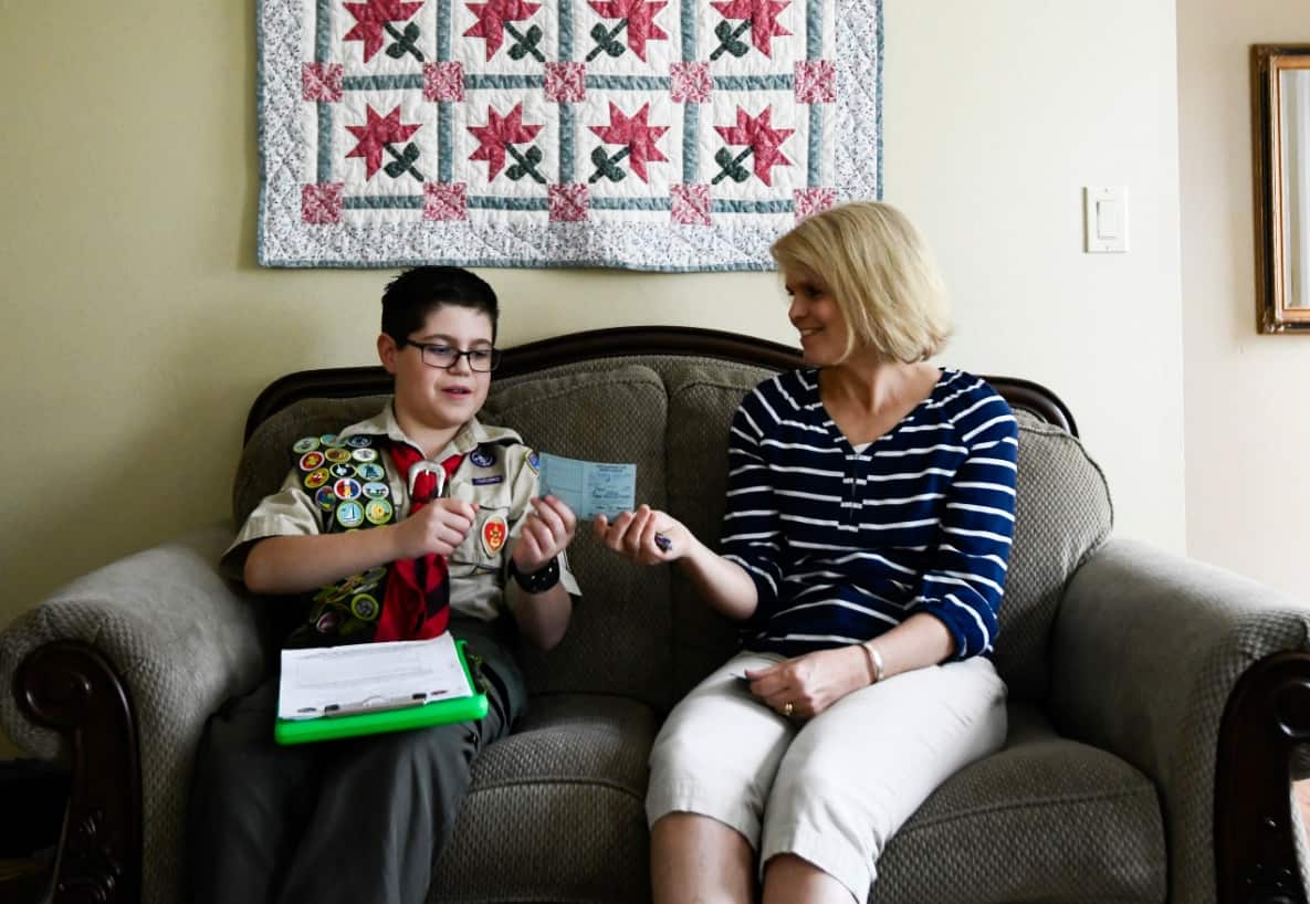 Seamus Thurston, 13, submits information for his personal fitness merit badge, his last needed before submitting for the Eagle Scout rank, to Paula Bergeson.
