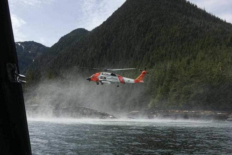A Coast Guard helicopter searches for an Australian and a Canadian, who were initially missing.