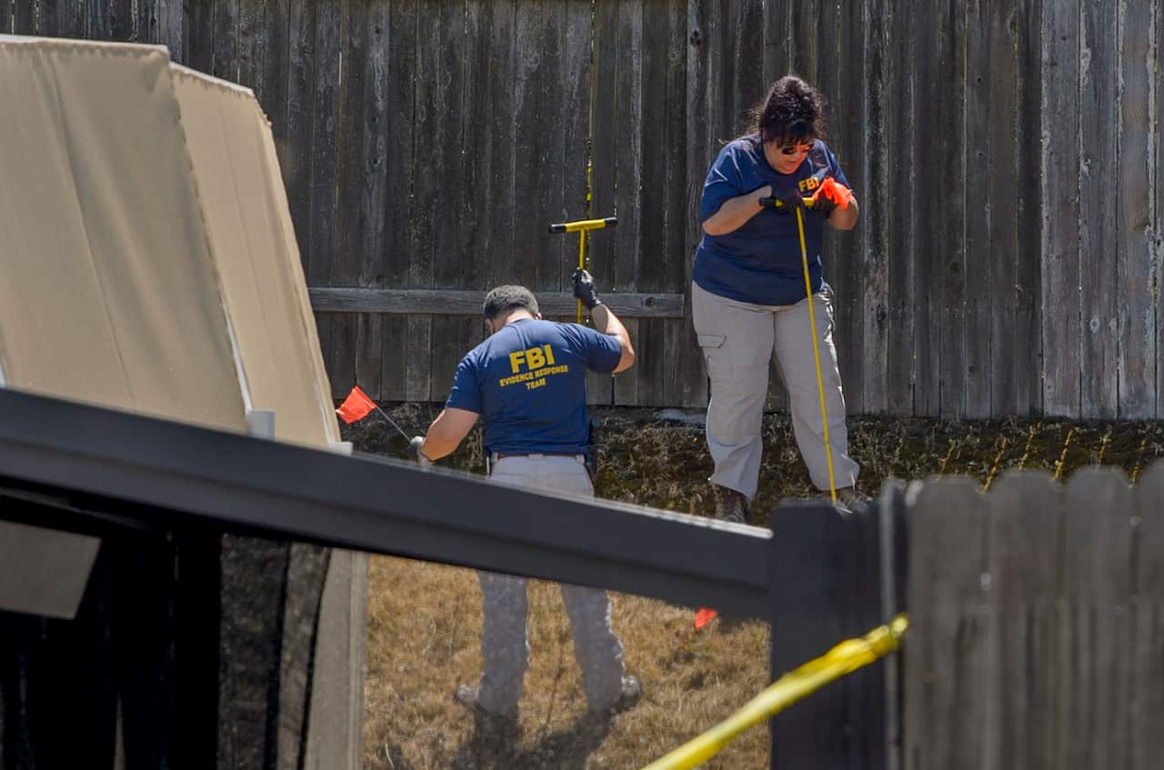 Law enforcement authorities process evidence at the home of suspected "Golden State Killer" Joseph James DeAngelo, 72. 