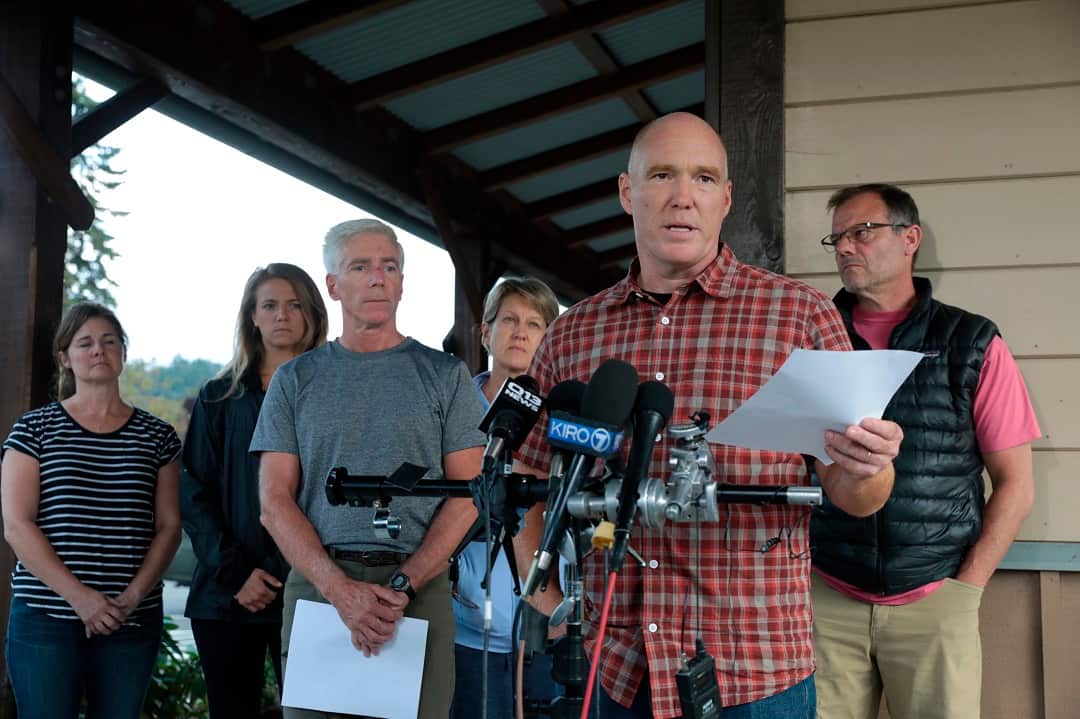 Mike Mathews and friends of Richard Russell talk to the media. 