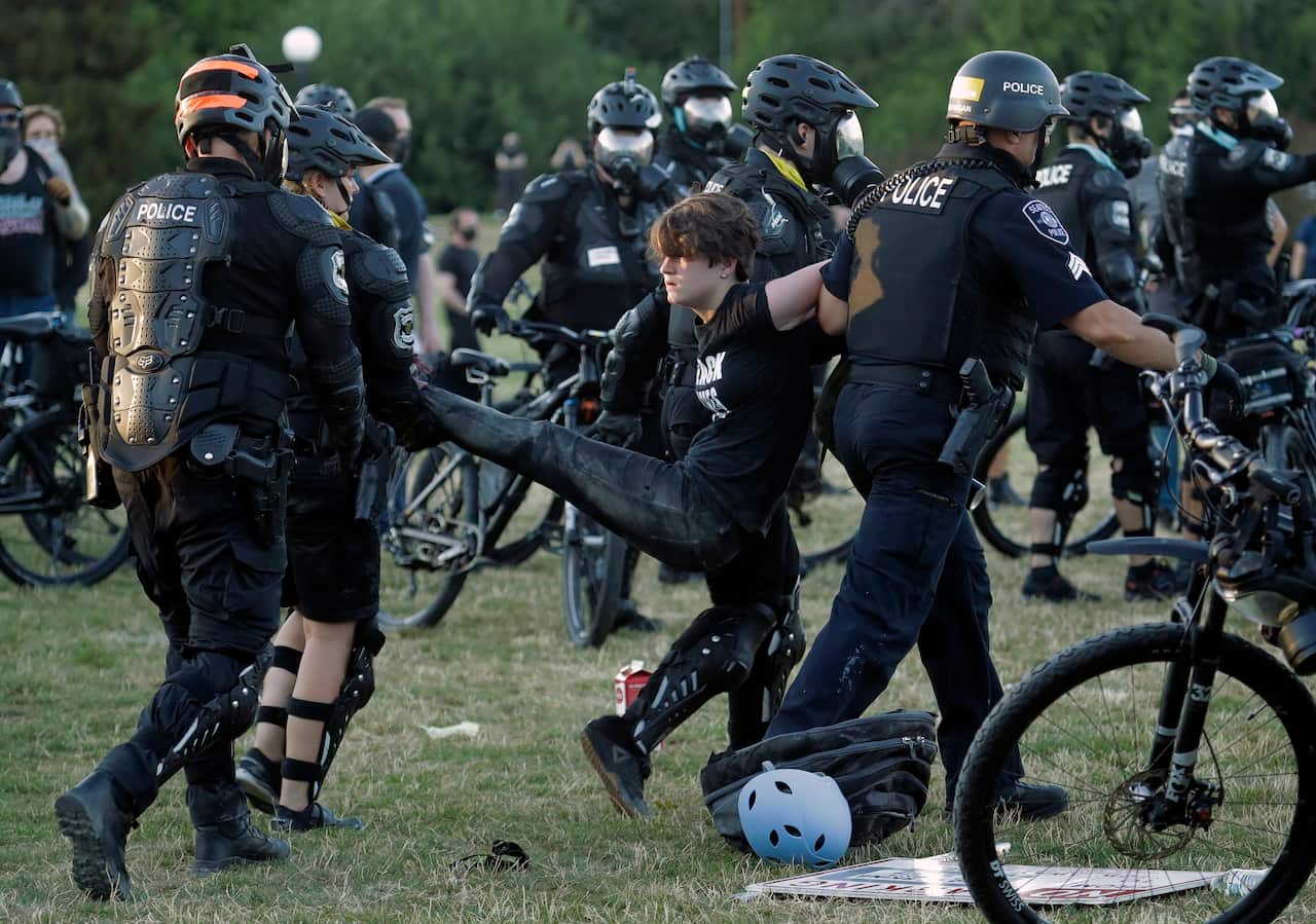 A person is arrested by Seattle Police at Cal Anderson Park, Saturday, July 25, 2020, during a Black Lives Matter protest.