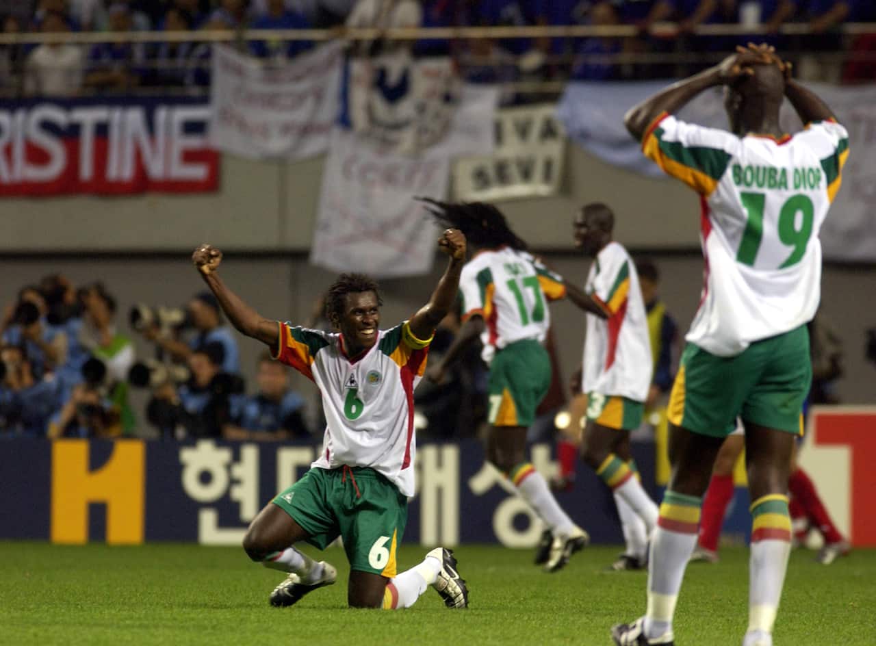 Aliou Cisse celebrates Senegal’s 1-0 win against France at the 2002 FIFA World Cup in South Korea, as goal scorer Papa Bouda Diop looks on