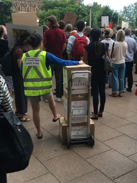 One demonstrator mocks the “thoughts and prayers” approach to policy. 