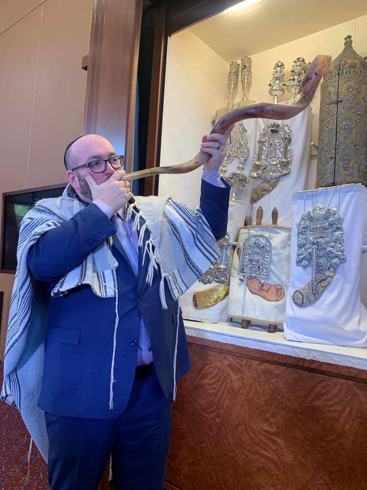 Rabbi Gersh Lazarow blows the shofar.