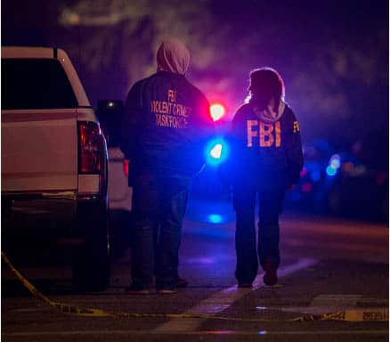 FBI and local officers at the scene, following the shooting which left 13 people dead.