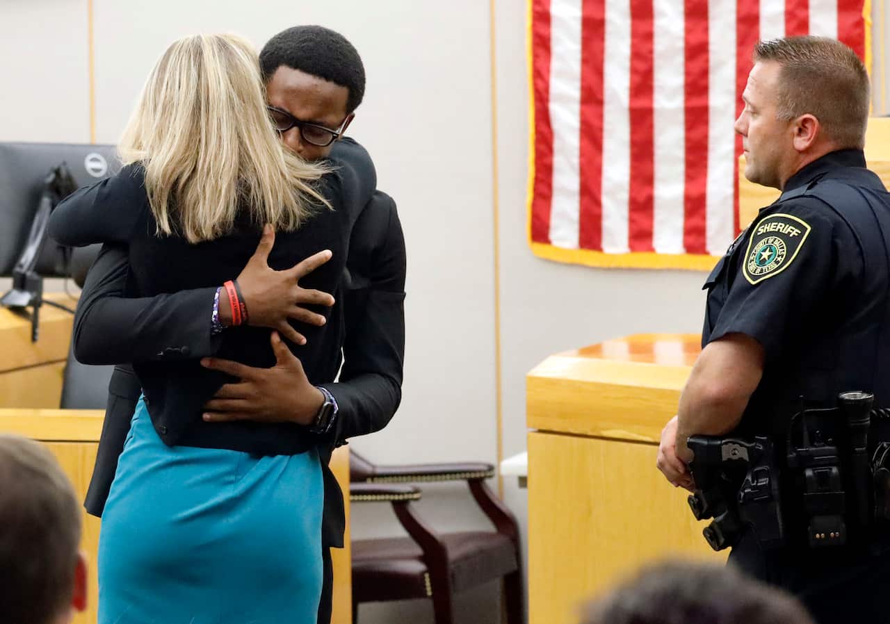 Botham Jean's younger brother Brandt Jean hugs convicted murderer and former Dallas Police Officer Amber Guyger after delivering his impact statement.