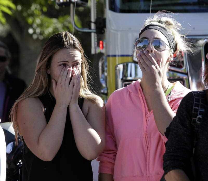 Alexis Tait, who lost a friend in the mass shooting at the Borderline Bar & Grill cries with Rachel Berg.