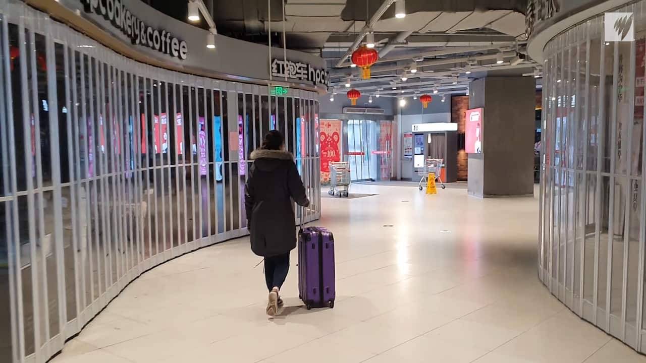 Ben Kavanagh goes grocery shopping with suitcases in deserted Wuhan.
