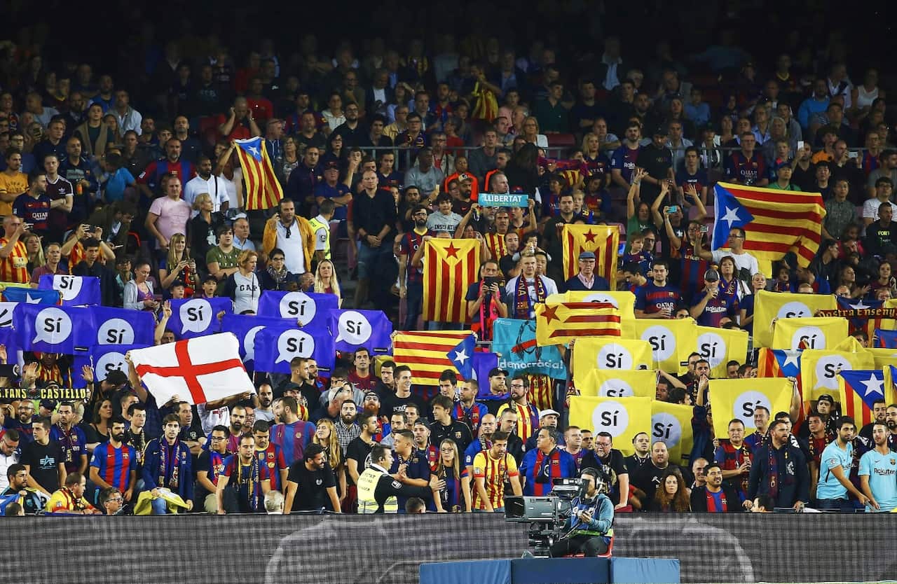 FC Barcelona fans hold signs supporting the Catalan independence during the Spanish Primera Division soccer match (AAP)