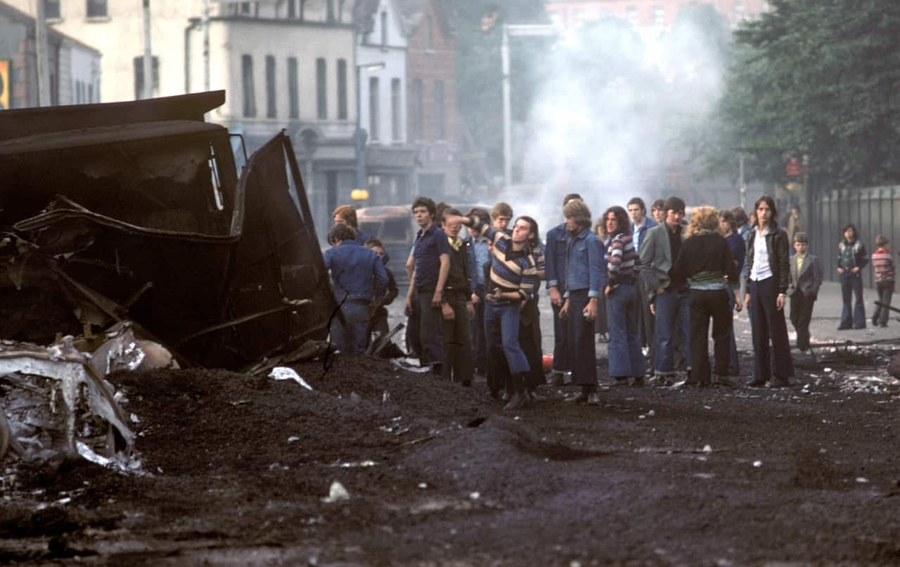 Nationalist youths throw stones at the British Army during riots in the Falls Road, West Belfast during The Troubles, in August 1976. (Getty)