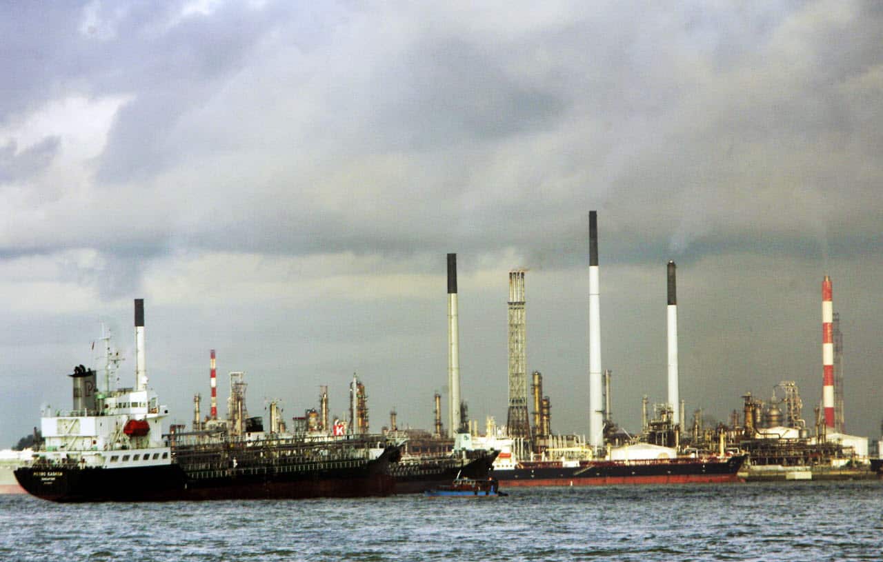 Ships anchor in front of the Jurong Island Petrochemical facility, a Singapore refinery, in this May 27, 2005 photo.