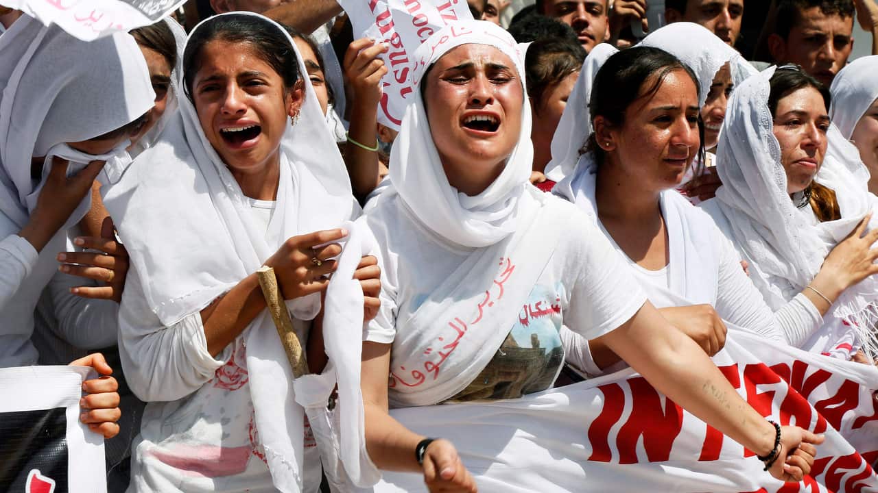 Yazidi Kurdish women chant slogans during a protest against the Islamic State group's invasion on Sinjar city on 3/8/15.