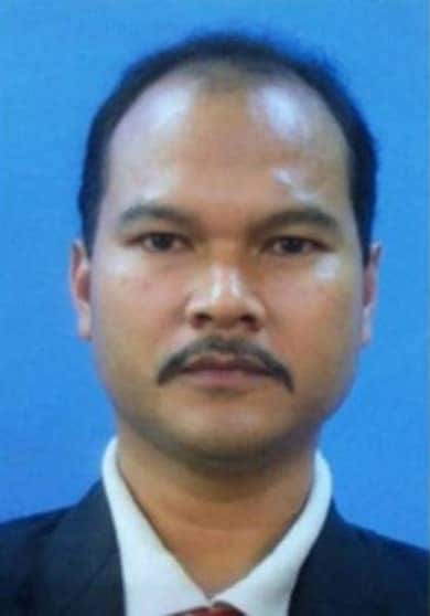 A headshot of Sirul Azhar Umar, who has short black hear, a moustache and is wearing a collared white shirt.