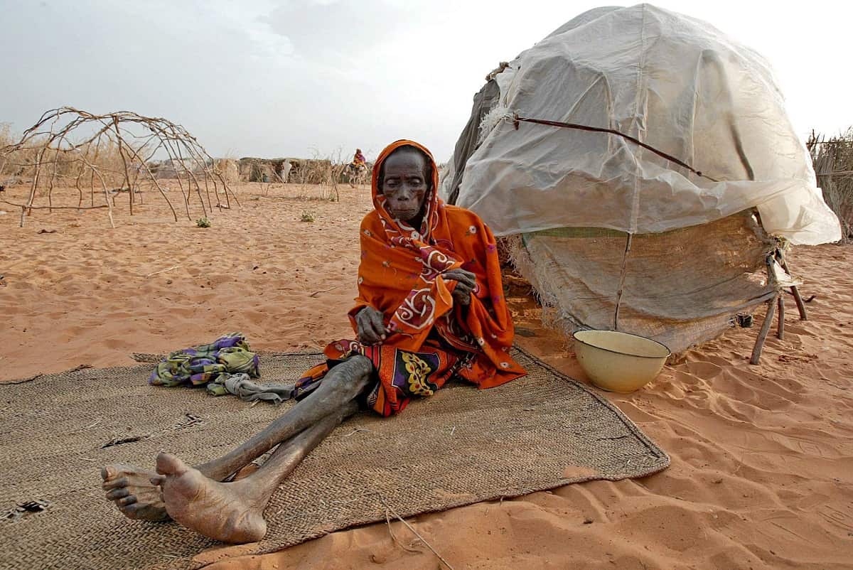 A file photograph dated 21 October 2004 showing a sick Sudanese Internally Displaced woman sitting outside her shelter in Muhajiriyah IDP camp, Darfur, Sudan. 