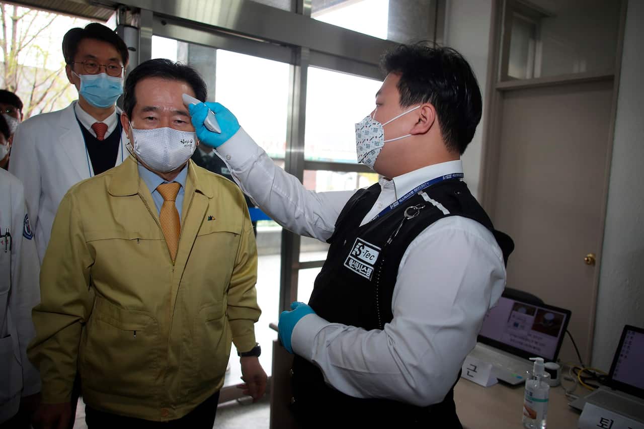 South Korean Prime Minister Chung Sye-kyun has his temperature checked upon his arrival at Dongsan Medical Center in Daegu, South Korea.