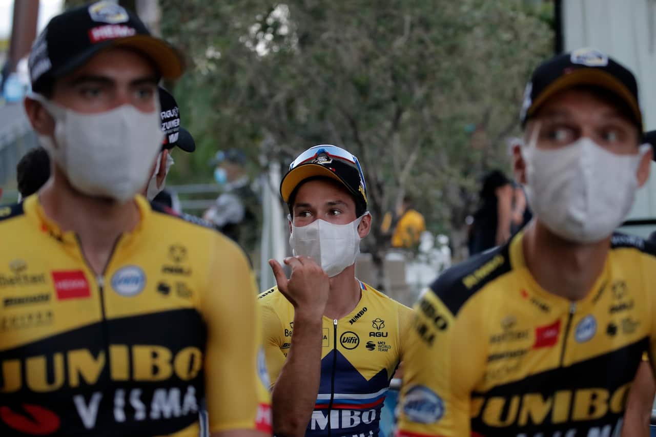 Slovenia's Primoz Roglic, center, Netherland's Tom Dumoulin, left, and German Tony Martin wear a face mask as they arrive for the 107th Tour de France