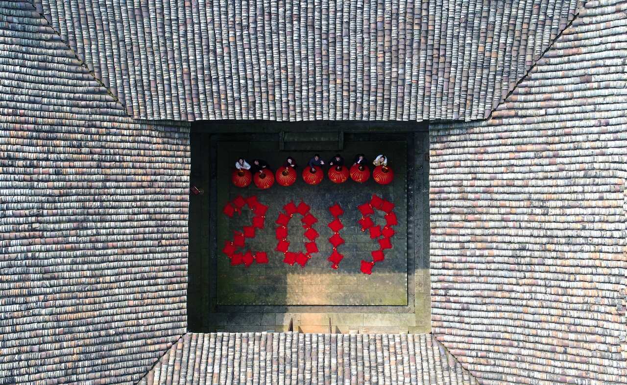 Aerial view of villagers holding red lanterns as they prepare to usher in the 2019 Chinese New Year, the Year of the Pig.