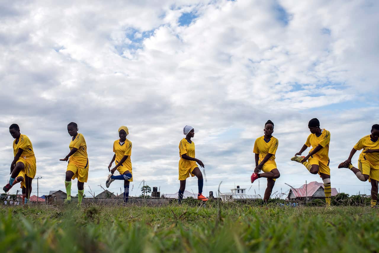 Green Queens players warm up before a soccer match, in Jumbi, Zanzibar.