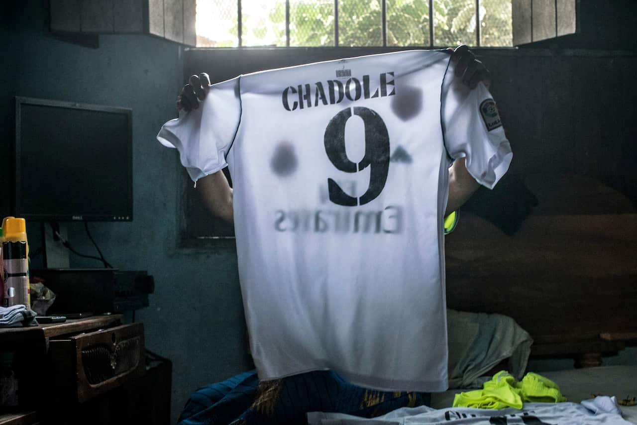 Riziki Abdallah, a star of the Zanzibari womens national team, holds up one of her jerseys at her home in the village of Dole.