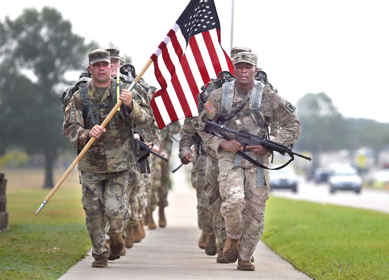 Soldiers carry the US flag as they make their way to the September 11 Remembrance Ceremony at Fort Gordon