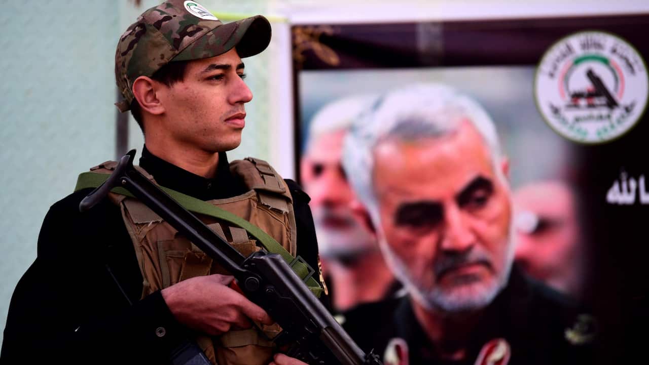 A member of an Iran-backed Iraqi Shiite armed group stands in front of a military base in Baghdad, 7 January 2020.