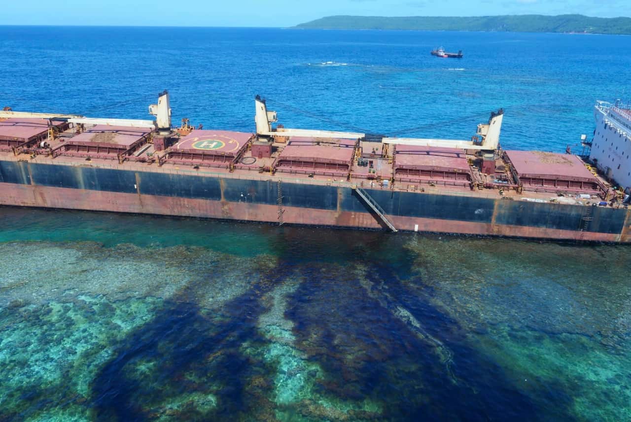 The Solomon Trader grounded on a reef during Cyclone Oma while collecting bauxite ore from remote Rennell Island.