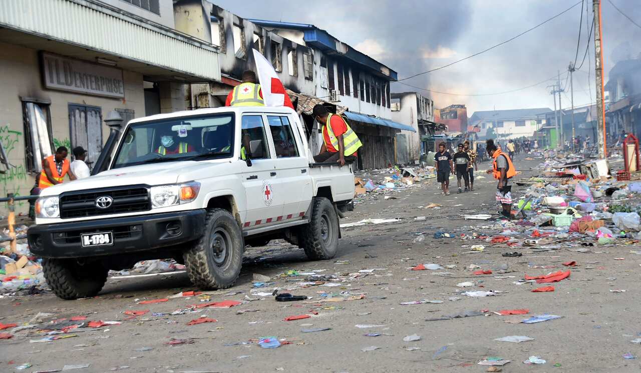 A Red Cross vehicle passes through the Chinatown district of Honiara on the Solomon Islands on 26 November, 2021.