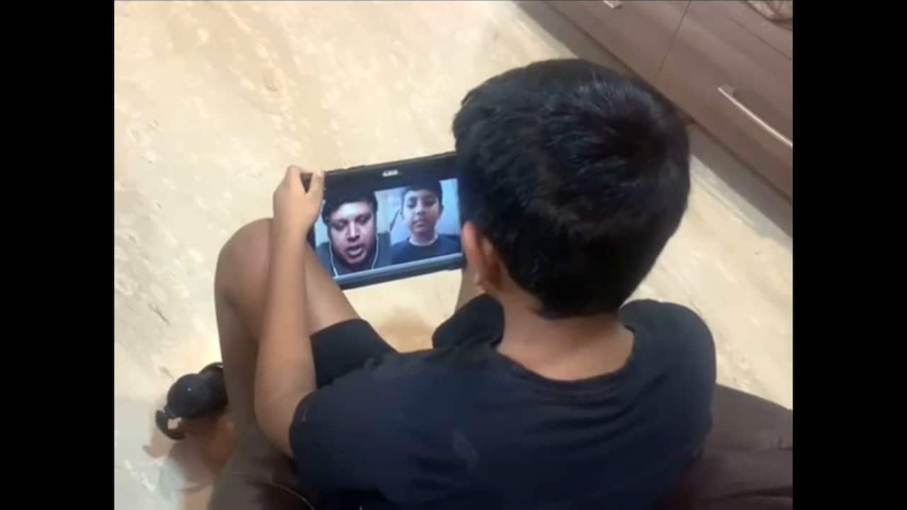 Dinesh Dhanraj converses with his son, Advaiith Dinesh, in a video call. 