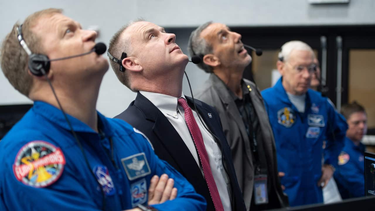 NASA astronaut Eric Boe (L) and Norm Knight, deputy director of flight operations at NASA's Johnson Space Center, watch the launch.