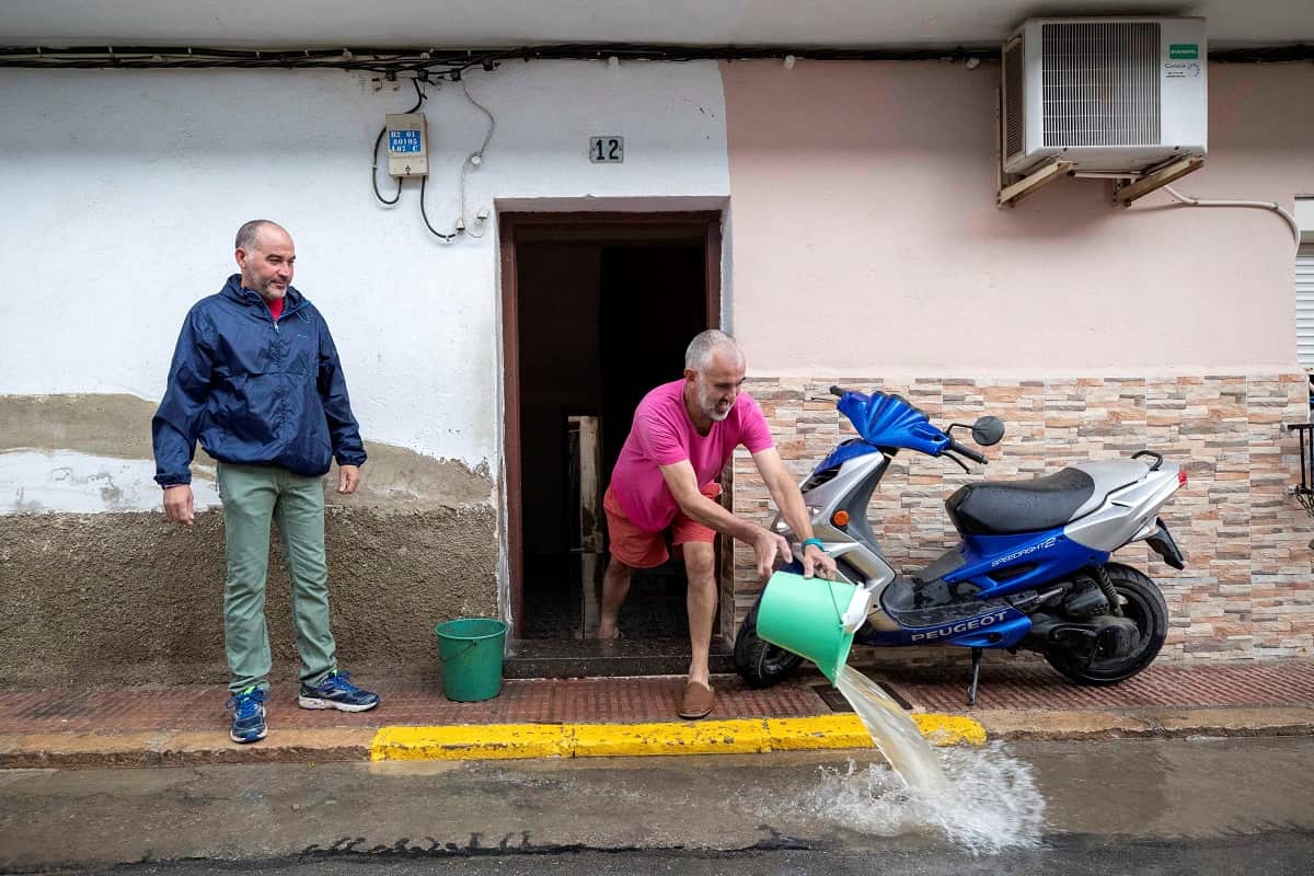 A man clears his home off water on a flooded street in Blanca, Murcia, Spain, 12 September 2019. 