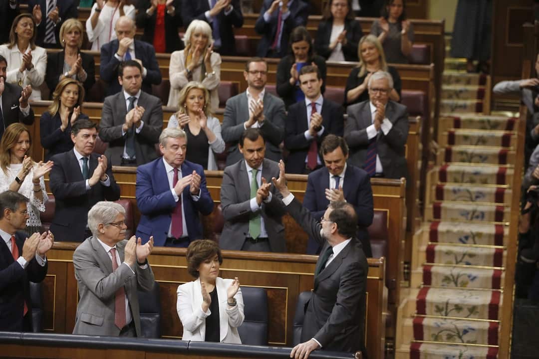 Spanish Prime Minister Mariano Rajoy applauded by his fellow party members.
