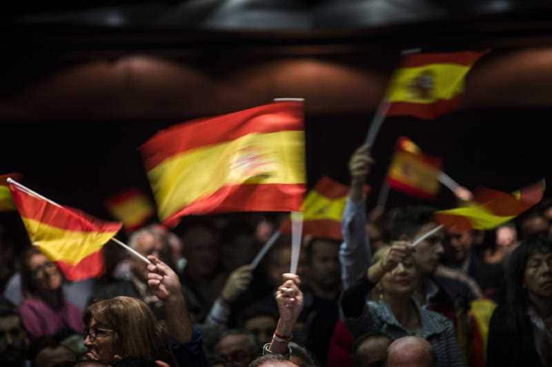 Supporters of Spain's far-right Vox party, the newcomer to the right of Spanish politics, wave flags during a rally in Murcia, Spain.