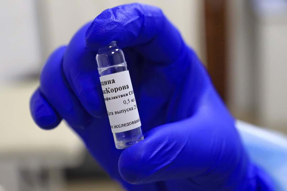 A medical worker holds an open vial of the EpiVacCorona vaccine against COVID-19, during post-registration clinical trials at Tyumen State Medical University.