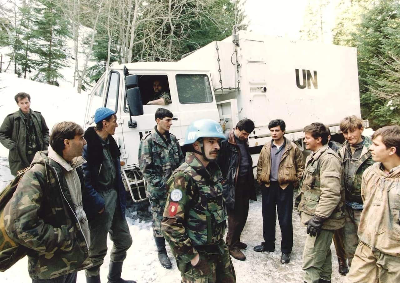 A file photo dated 01 March 1994 showing Dutch soldiers of a Dutchbat convoy chatting with Bosnian Muslim fighters in Vares, Bosnia