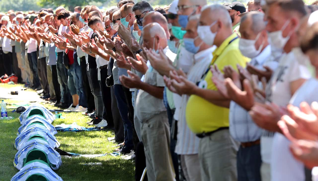 Bosnian Muslims pray during the funeral in the Potocari Memorial Center, Srebrenica, Bosnia and Herzegovina, 11 July 2020.