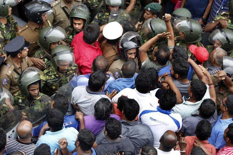 Sri Lanka Police Special Task Force personnel clash with protesters following the shooting. 