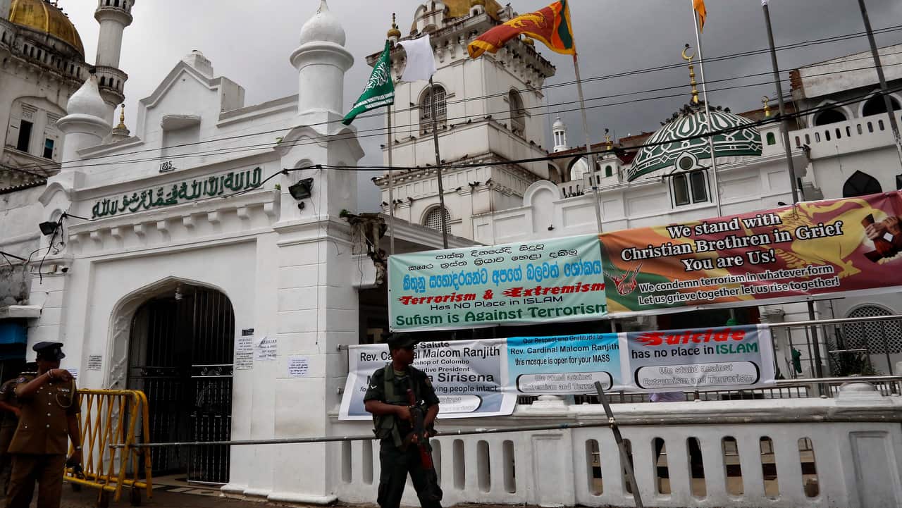 Sri Lankan security forces stand guard at Dawatagaha mosque during Friday prayers at Town Hall in Colombo.
